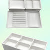 A white plastic drawer organizer tray with multiple compartments shown in stacked and open views.