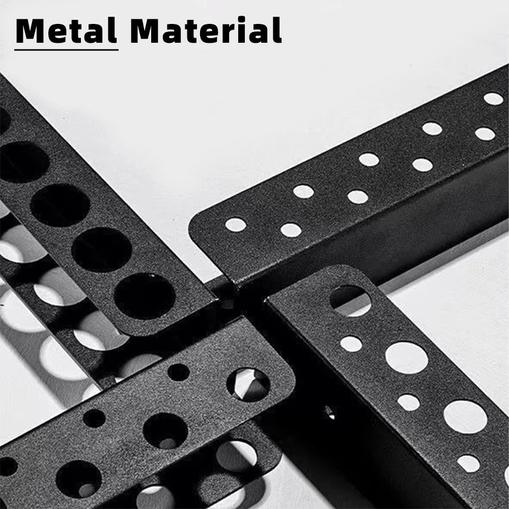 A close-up view of a black metal material tool storage rack with multiple circular holes.