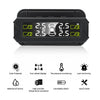 A black solar-powered tire pressure monitoring system device showing real-time pressure readings and alerts.