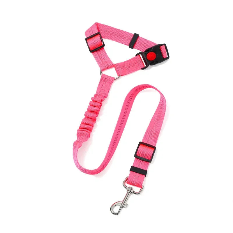 A bright pink adjustable reflective dog car safety harness with a black headrest strap and metal clip.