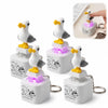 A white seagull figurine keychain fidget toy with an LED light resting on a clear base.