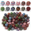 A collection of colorful resin rhinestone beads in various two-tone striped designs and colors.