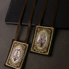 A brown scapular necklace with an ornate pendant featuring a depiction of the Immaculate Heart.