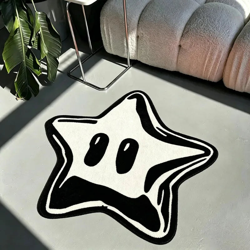 A black and white irregular pentagram rug is displayed on a light surface next to a potted plant and a textured cushion.