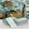 Stacks of light green marble self-adhesive wall stickers displayed against a teal and gray marbled background.