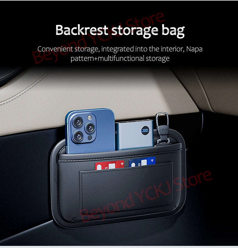 A black storage bag organizer is placed in a car seat side pocket, holding a smartphone and a small device.
