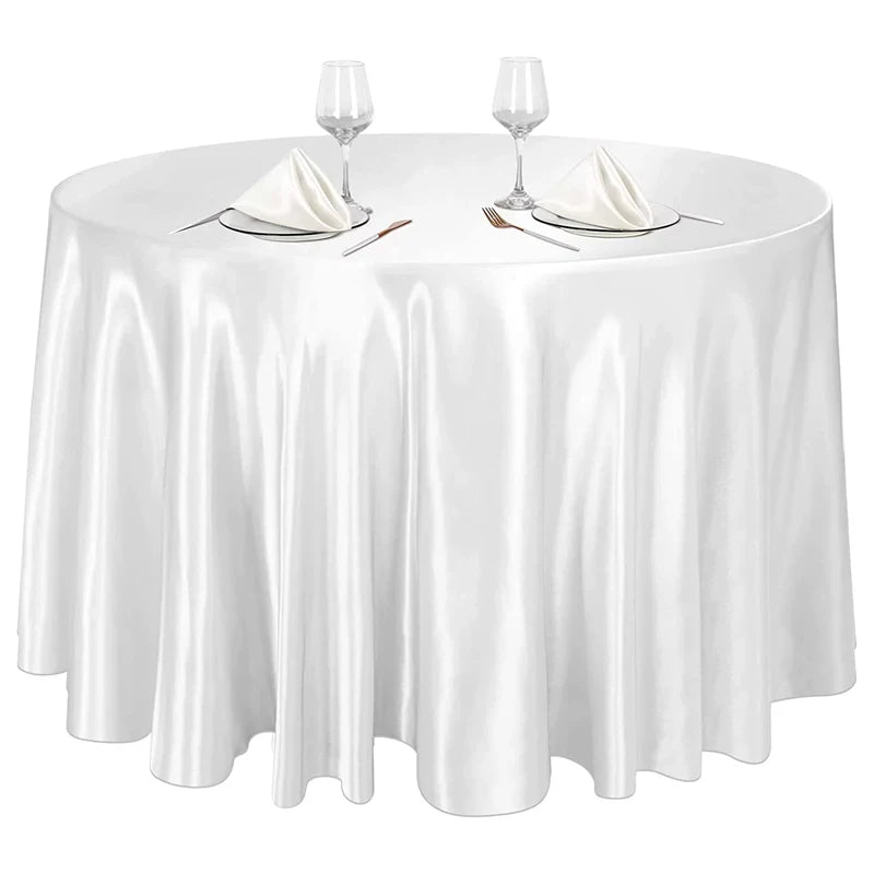Elegant satin round tablecloth set with glassware and silverware for events