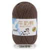 A skein of brown milk cotton blend yarn labeled with Chinese and English text, showing the thread for knitting or crochet.