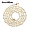 A strand of small, round, off-white pearls on a gold-toned chain with a clasp.