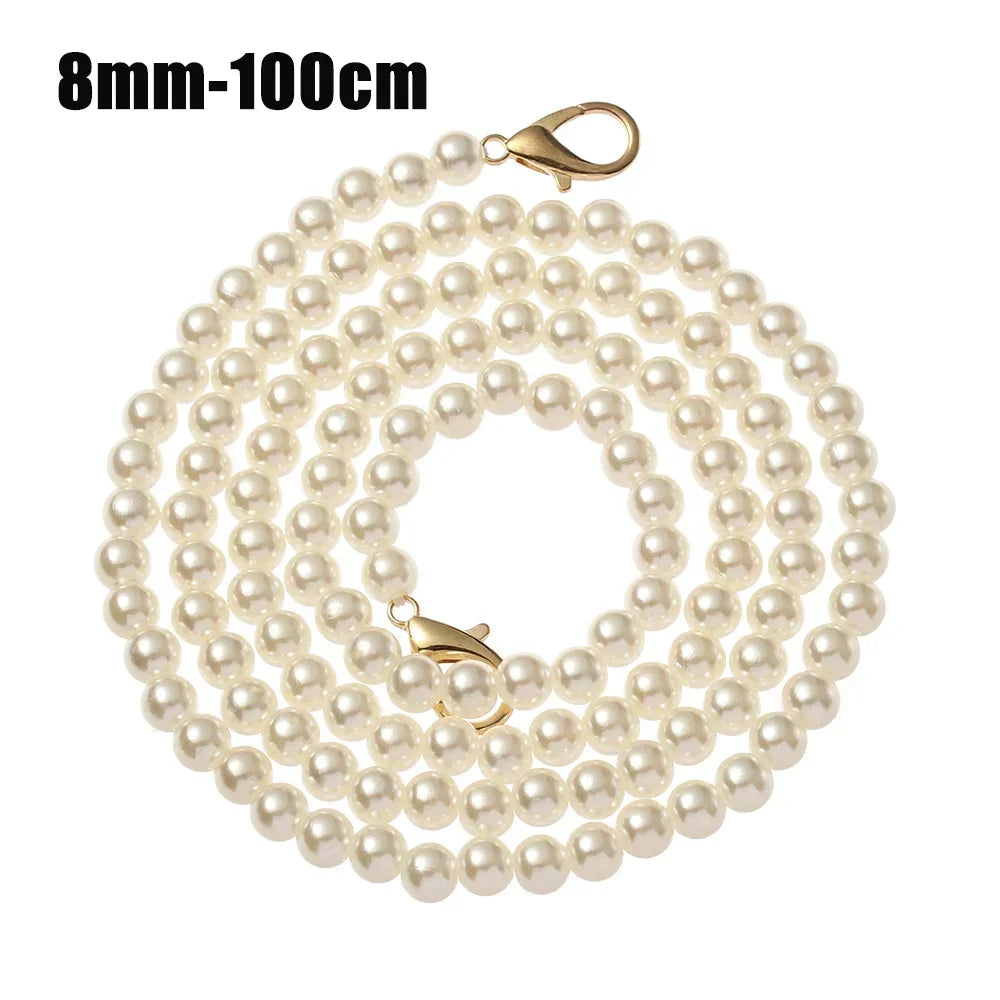 A strand of small, round, off-white pearls on a gold-toned chain with a clasp.