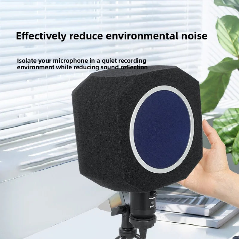 A black microphone foam isolation shield is shown on a desk, designed to reduce sound reflection.