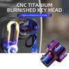 A close-up view of a polished titanium key head cover with a textured finish, shown against a blurred background.