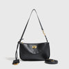 A black leather tote bag with a long strap and a gold-toned metal buckle.