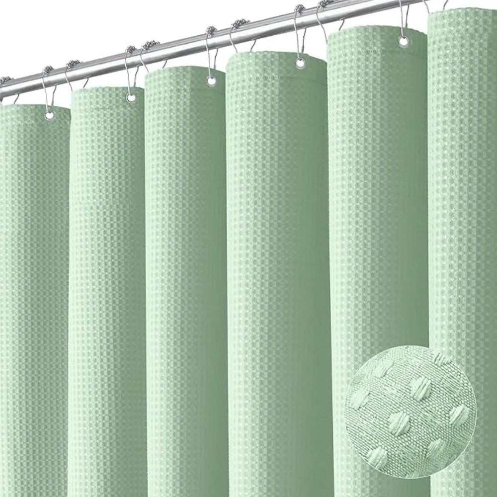 A row of light green waffle textured shower curtain rings hanging from a metal rod.