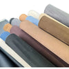 A collection of self-adhesive suede fabric rolls in various earth tones and neutrals, displayed in a row.