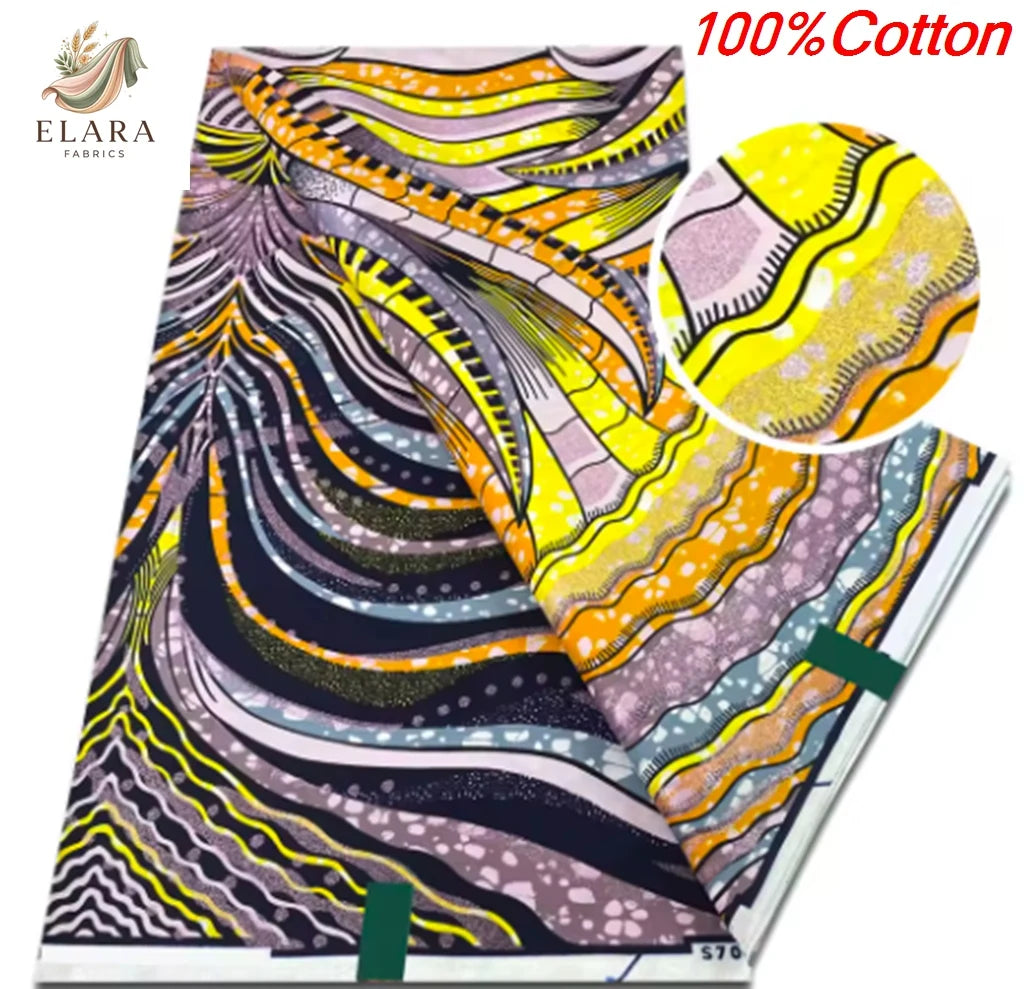 A close-up view of a vibrant pink, yellow, and purple African wax print fabric with swirling patterns.