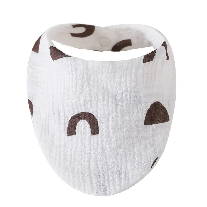 White organic cotton muslin baby bibs with a textured fabric and dark brown animal print shapes