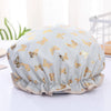 Light blue reusable elastic shower cap decorated with gold butterfly patterns