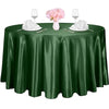 A dark green satin tablecloth set for an elegant table with pink flowers and glassware.
