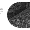 Close-up view of a black geometric non-slip rug texture showing firm grip and durability.
