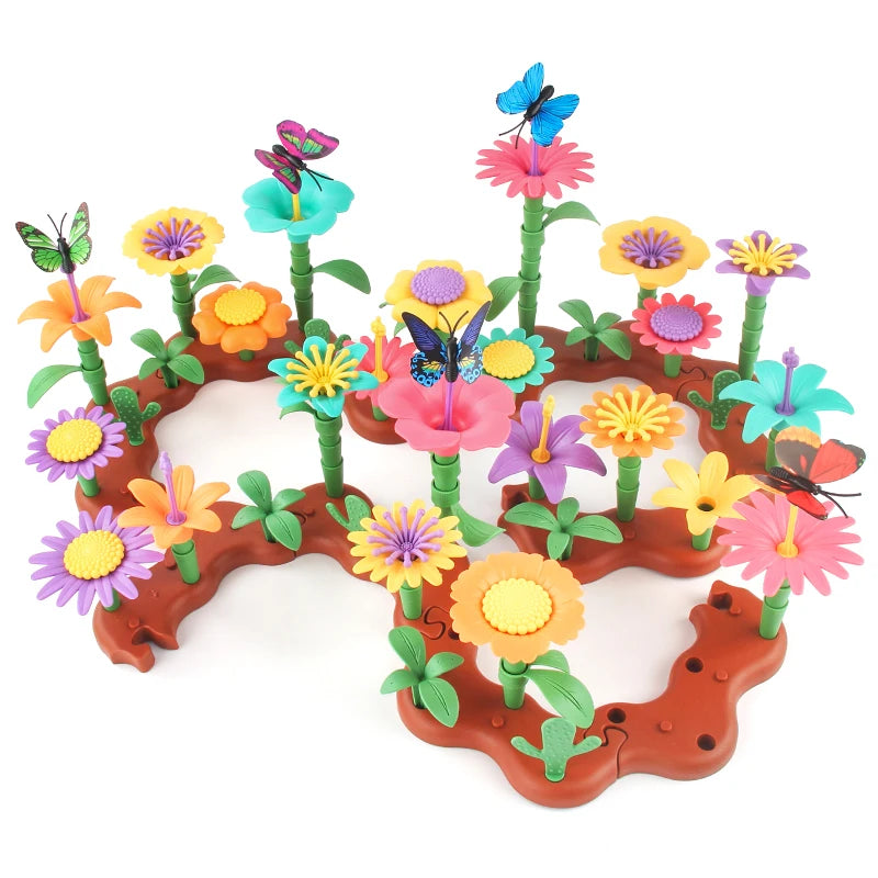 A colorful building toy featuring various flowers and butterflies growing from brown terrain.