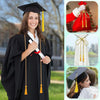 A smiling woman in a black graduation gown is holding cords with yellow tassels, demonstrating the product for ceremonies and