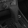 A close-up of a black PU leather car gear shift cover with a stitched pattern resting on a vehicle console.