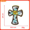 Embroidered cross patch with a yellow flower detail on a beige background
