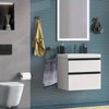 A bathroom setup featuring a mirror, sink cabinet, and various stainless steel accessories like towel rings and hooks on a ti