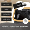 A laundry hamper with a wooden frame and black fabric, showing different wash classifications like delicates, dark, hot wash,