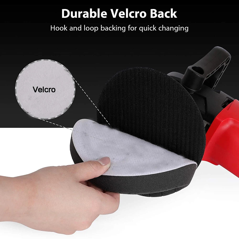 A hand is holding a black polishing sponge pad with a velcro backing, demonstrating the hook and loop feature.