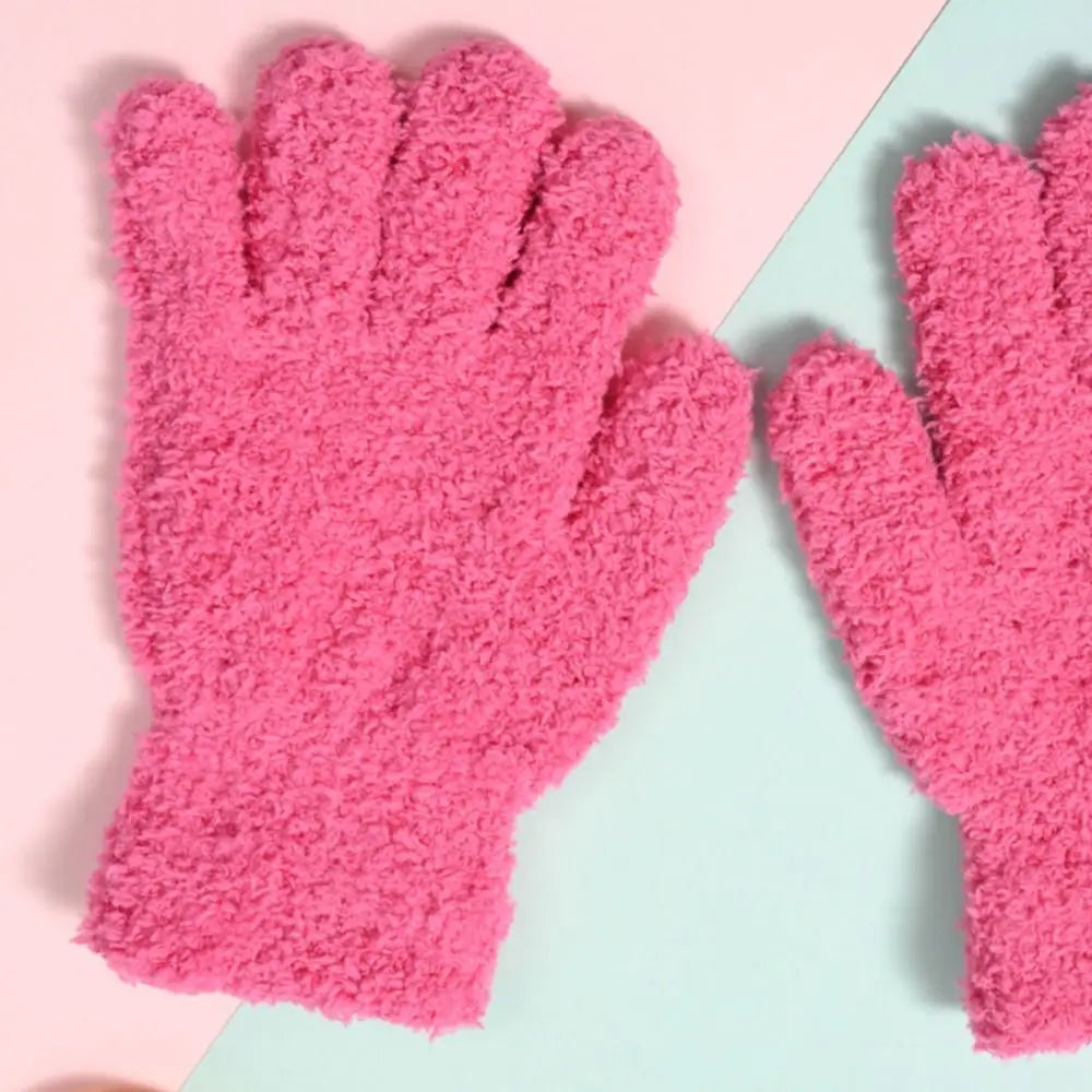 A pair of bright pink, fuzzy plush winter gloves for kids displayed against a light background.
