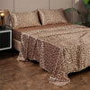 Luxury satin leopard print bedding set featuring brown and beige animal print fabric on a bed.