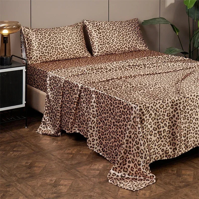 Luxury satin leopard print bedding set featuring brown and beige animal print fabric on a bed.