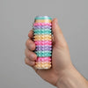 A hand holds a colorful spiky sensory fidget roller with stacked, rotating segments.