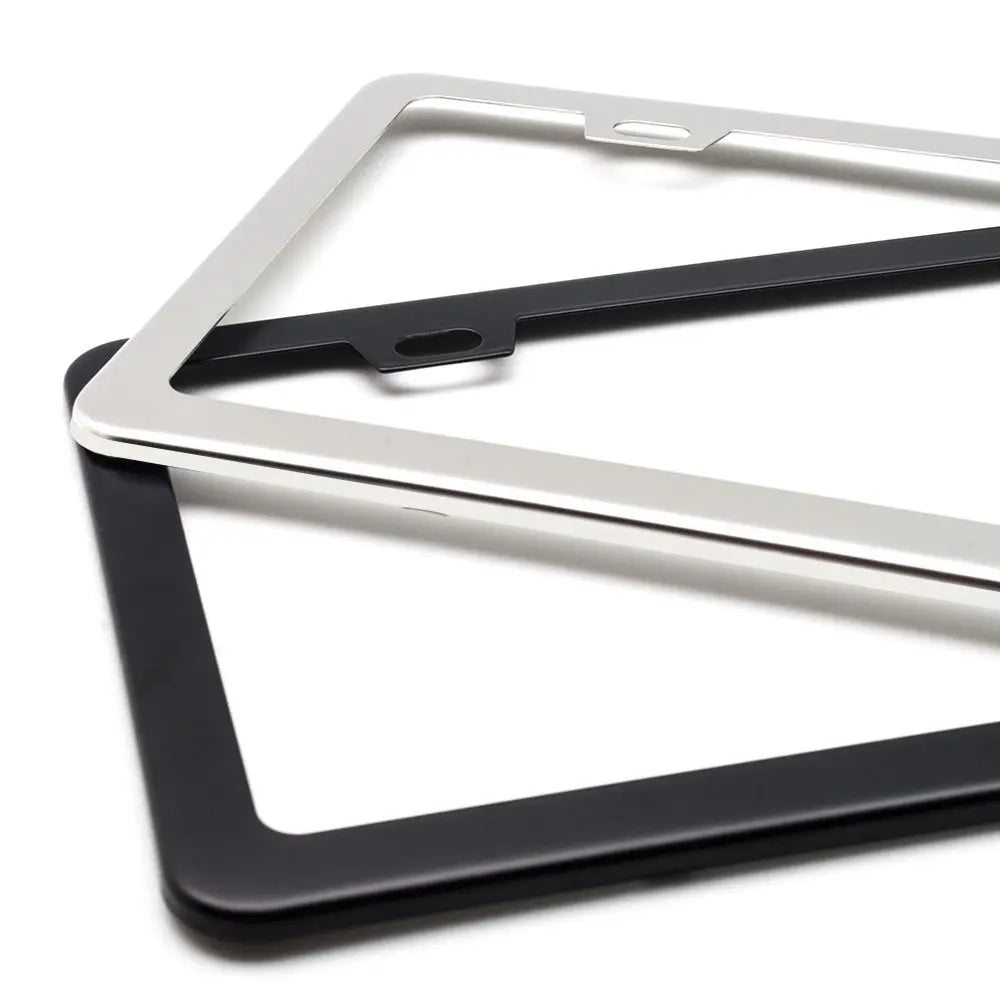 A set of two stainless steel license plate frames, one silver and one black, displayed against a white background.
