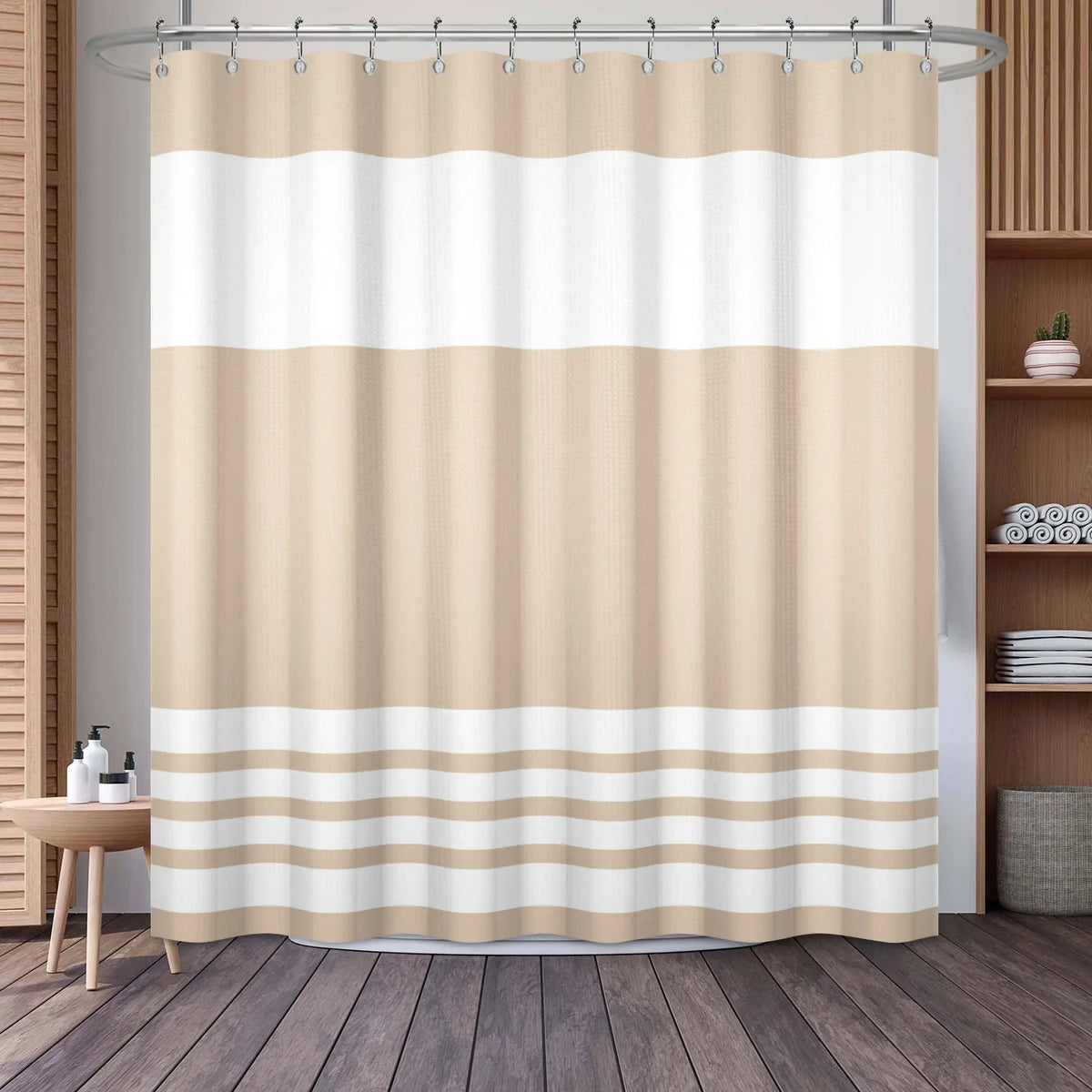 A beige and white striped waffle weave shower curtain hanging on a rod.
