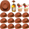 A set of miniature brown cowboy hats used as party favors and cake toppers, displayed next to a bottle of oil and fresh berri