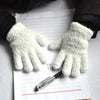 A pair of white, fluffy plush winter gloves resting on a lined piece of paper.