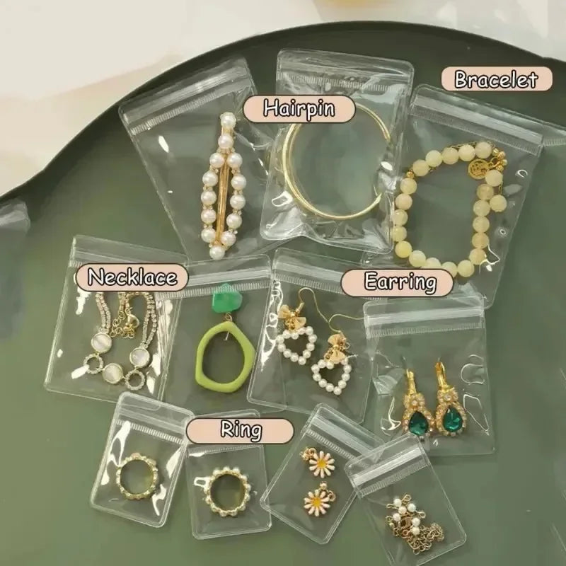 Various pieces of jewelry like earrings necklaces rings and hairpins are stored in clear self-sealing plastic bags