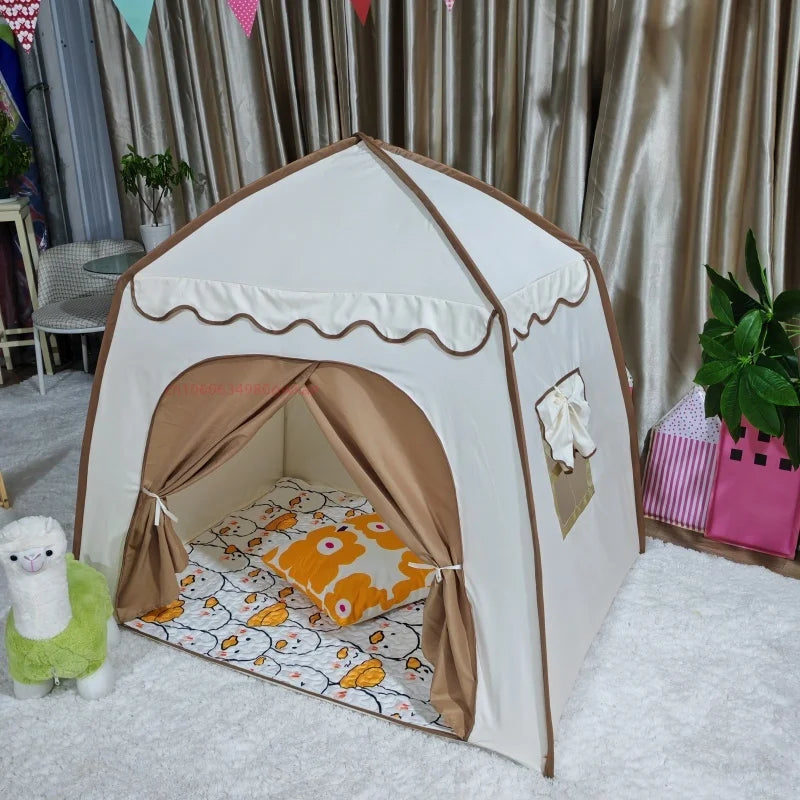 A beige and white foldable kids teepee play tent with a curved entrance and ventilation windows set up indoors.