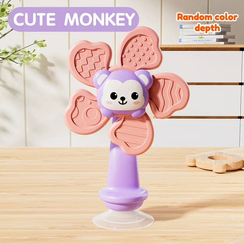 A cute monkey toy with pink ears and purple body standing on a clear base.