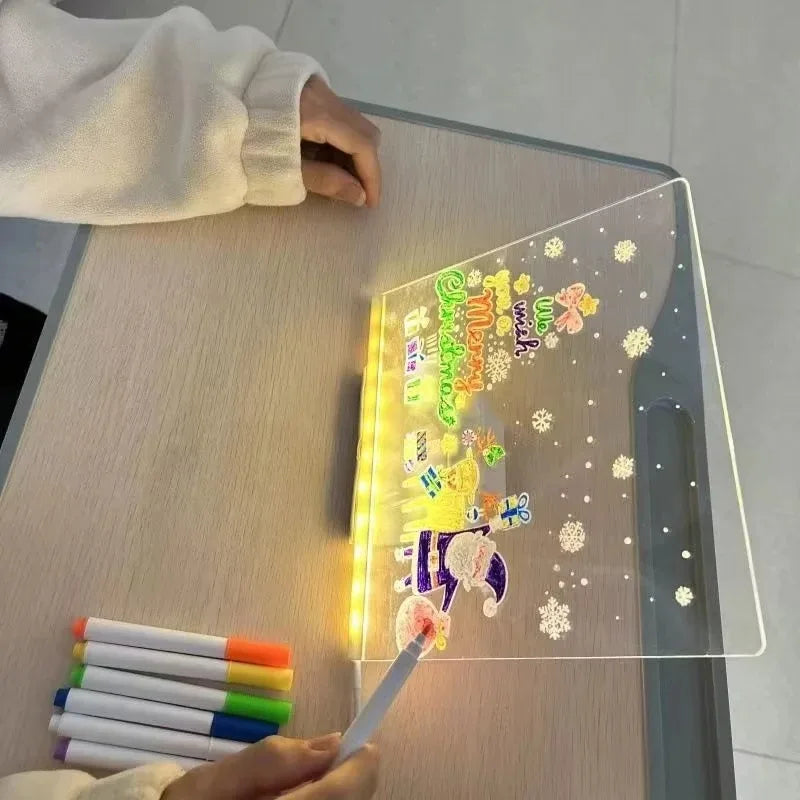 A glowing LED drawing board is shown on a table with a hand holding a colored pen.