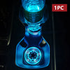 A close-up view of a blue LED cup holder light installed in a car interior, showing the illuminated design.