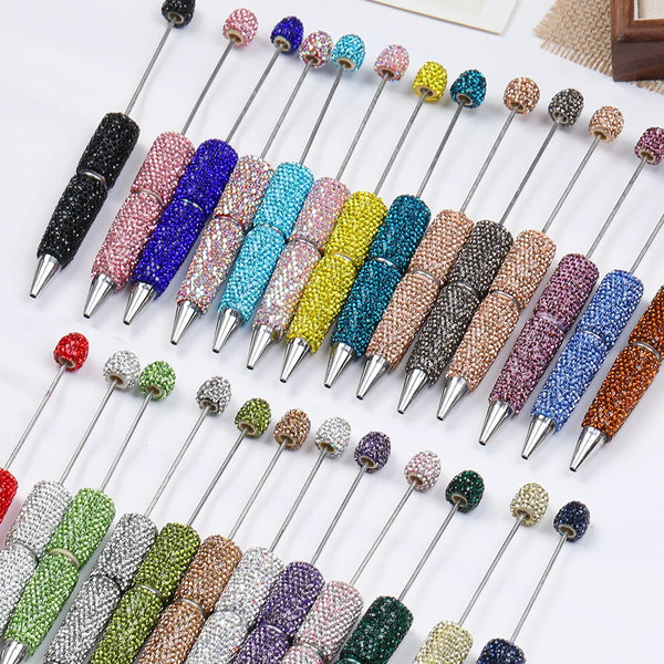 A collection of decorative beaded pens in various colors and finishes for DIY jewelry making