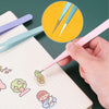 A hand uses a pink precision craft tweezer to pick a drawing of a pineapple on a lined notebook.