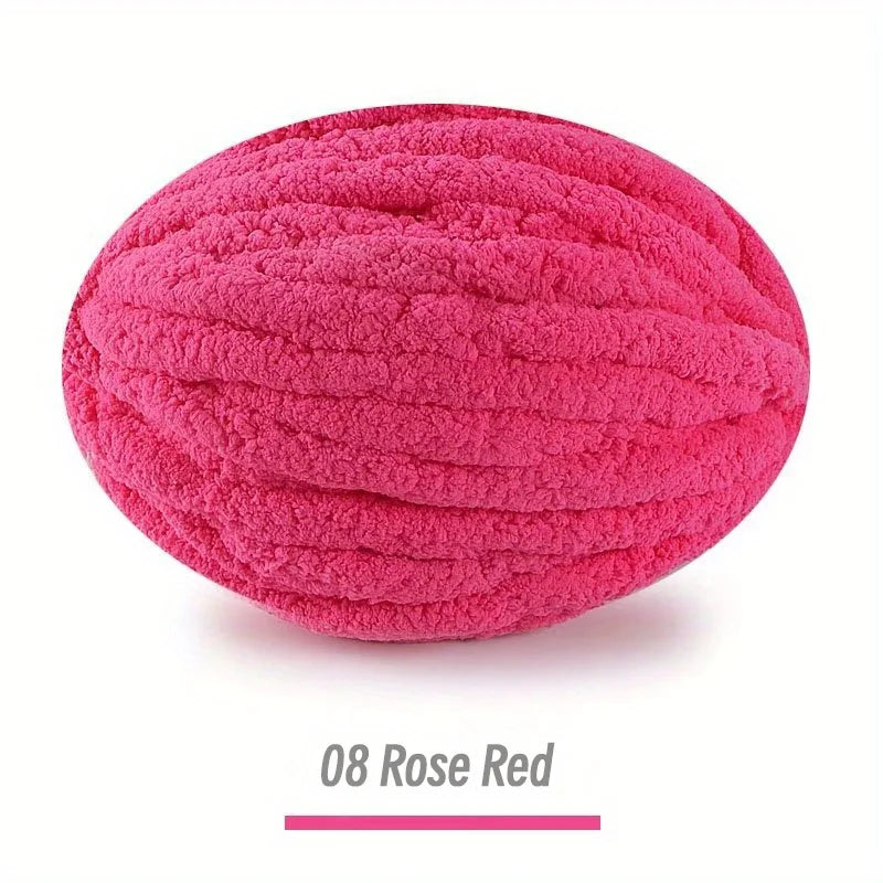 A ball of bright pink rose red chenille yarn for hand knitting projects.