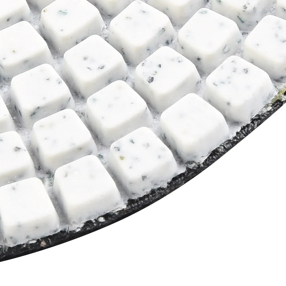 A set of white diamond polishing pads for stone and concrete, showing various grits.