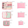 A set of six pink and pastel colored packing cubes, including a zippered pouch and various sized storage bags.