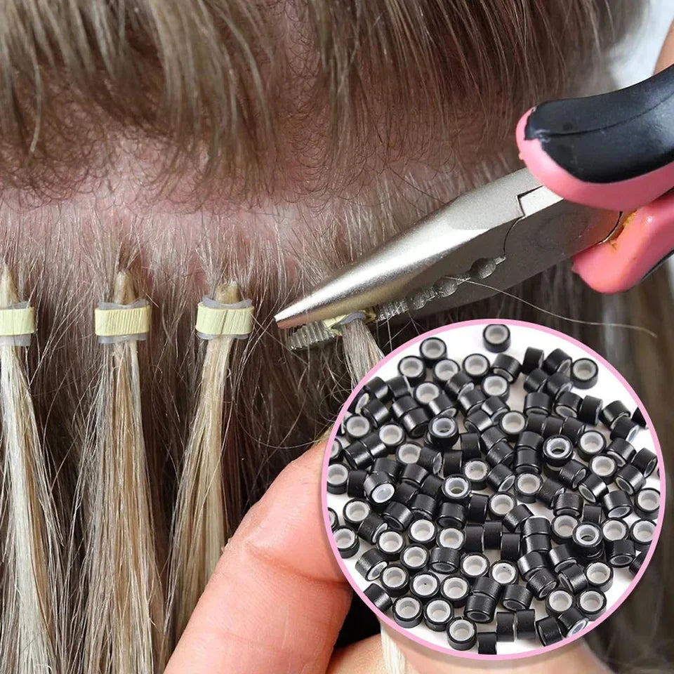 A hand holds a pink tool with a needle to install hair extensions using silicone-lined micro rings.